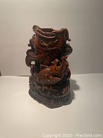 Front and side view of deep red resin-colored carp fish figurine showing details of scales, fins, and open top area.