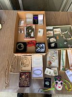 Overview photo showing multiple pieces of jewelry including beaded necklaces, pins, brooches, earrings, and a 10 Commandments bracelet.
