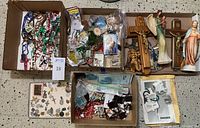 Full view of all boxes showing rosaries, medals, crucifixes, figurines, and icons as a lot