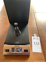 Bell-shaped silicon ingot placed on digital scale showing weight 0.40 lb (approx 6.4 oz)