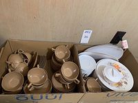 Box with creamy mocha Aztec Melmac cups, small bowls, dessert plates and two serving bowls on left; Lenox Ware plastic dinner plates with fall floral design, white coffee saucers, serving platters and sugar bowl on right.