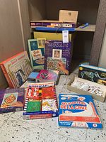 Photo showing various vintage craft and model kits including mosaic, paint by numbers, model mastodon and robot kits.