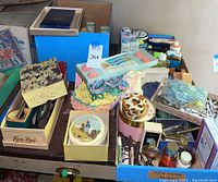 Photo showing the assortment of vintage toiletries, soaps, powders, and cologne bottles on and around a table