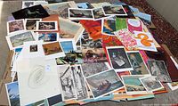 Large assortment of overlapping prints, posters, and art pieces showing variety of styles and subjects