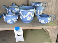 All five pieces displayed on shelf: teapot, covered sugar bowl, creamer, pitcher and cache pot