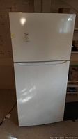 Front view of white LG top freezer refrigerator showing full appliance in standing position.