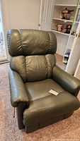 Front view of the green leather-like La-Z-Boy recliner chair showing cushioned seat and backrest.