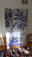 Front view of the three-panel floral room divider showing large blue leaf and flower design on white background.