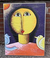 Front view of cubist painting featuring a woman with doves on her shoulders and vivid colors.