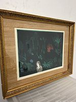 Framed linocut print with depiction of girl and jungle plants, showing overall condition and frame details.