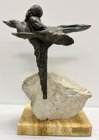 Front view of bronze sculpture showing both figures and stone base