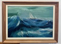 Front view of the framed oil painting showing the yacht and turbulent ocean waves under cloudy sky.