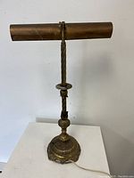 Full view of gilt metal gallery desk lamp with visible cord and base details