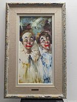 Framed oil painting of two clowns with vibrant colors and signed B HELO.