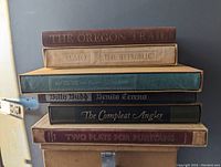 Stack of six classic hardcover books with titles visible, showing condition and style.