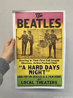 Front view of the vintage Beatles concert poster held by a hand showing size and condition.