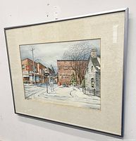 Framed mixed media winter scene painting showing weathered mat and metal frame.