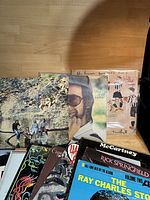 Photo of 10 assorted used classic vinyl record albums including John Lennon, Paul McCartney, Elton John, Ray Charles, Rick Springfield with visible album covers.