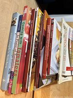 Ten assorted cookbooks standing upright with titles visible.
