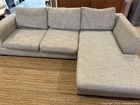 Front view of grey sectional couch with chaise