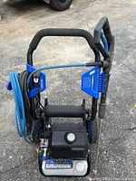 Full view of the Kobalt electric power washer showing the frame, hose, handle, and motor block.