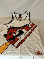 Front view of white tank top with black edging and large colorful graphic of Air Jordan sneaker on an ice cream stick.