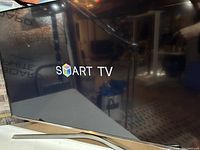 Front view of the Samsung 48" Smart TV showing the screen powered on with 'SMART TV' displayed.