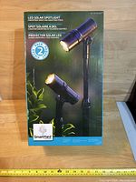 Front view of the boxed set of two SmartYard LED solar spotlights showing product image and basic features.