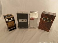 Four boxed men's colognes lined up: Hollister SoCal, Azzaro Onyx, Diesel Plus Plus, Aramis