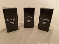 Three new boxed bottles of Abercrombie Clutch men's cologne, 30ml each, standing upright showing front packaging.