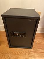 Front three-quarter view of closed safe on wood floor