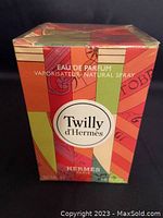 Front view of the original box showing colorful abstract design, product name Twilly d'Hermes, and labeling as Eau de Parfum vaporisateur natural spray.