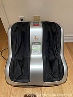 Front view of massager showing foot sleeves and overall device design