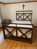 Assembled bed frame with mattress in room