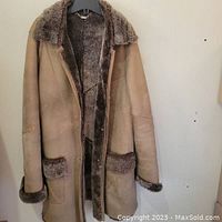 Front view, coat open showing suede exterior and shearling interior