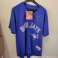 Full front view of blue Blue Jays jersey hanging on black hanger