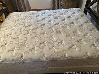 Full view of mattress top showing tufted floral design and overall condition