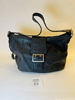 Full view of the black leather Banana Republic purse with visible clasp and shoulder strap.