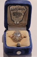 Front view of ring in original velvet box showing ring and box interior