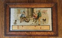 Frontal view of one lithograph in original oak frame showing two men and boys with dogs, includes text panel at bottom.