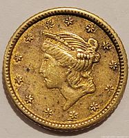Obverse of 1852 Liberty Head Type I gold dollar showing Lady Liberty profile and 13 stars