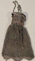 Front view of the vintage Chatelaine style metal mesh misers purse showing the chain handle and detailed top clasp.