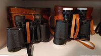 Carl Zeiss Jena Deltrintem 8x30 and Baker Standard Grandview 7x35 binoculars side by side with leather cases