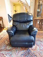 Front view showing padded seat cushion, armrests and overall leather condition