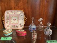 Full lot view: one painted Limoges decorative tray with floral and gold details and bow handles; two small floral decorative boxes; four small perfume bottles, one cracked.