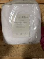 Front view of the Casaluna comforter packaging showing product name, size and features.