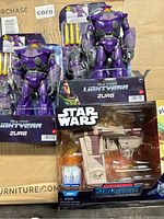 Photo of 3 toys showing two Lightyear Zurg action figures and one Star Wars Micro Galaxy Squadron Starfighter still in original packaging.