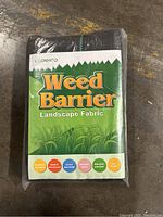 Front view of a sealed pack of USONHOO Weed Barrier Landscape Fabric, showing the product name, benefits, and green grass graphic.