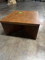 Front side view of solid wood square coffee table showing tabletop and legs