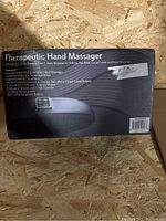 Box of SereneLife Therapeutic Hand Massager showing model and therapeutic benefits